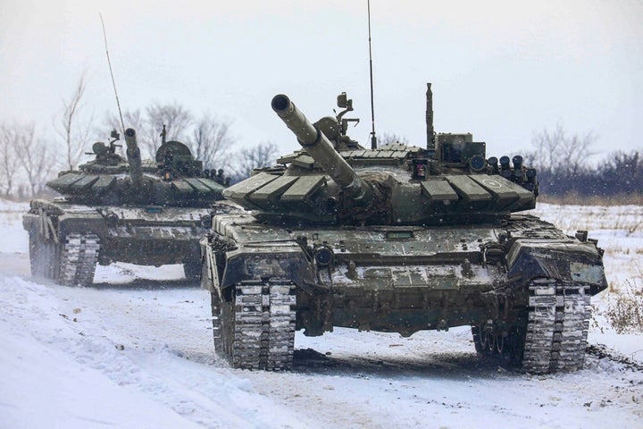 In this photo provided by the Russian Defense Ministry Press Service on Monday, Feb. 14, 2022, Russian tanks roll on the field during military drills in Leningrad region, Russia. (Russian Defense Ministry Press Service via AP)