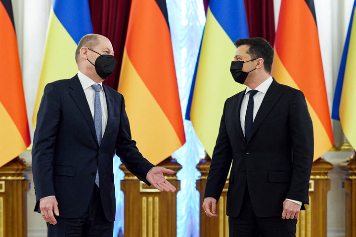 In this handout photo provided by the Ukrainian Presidential Press Office, Ukrainian President Volodymyr Zelenskyy, right, listens to German chancellor Olaf Scholz while posing for a photo during their meeting at The Mariinskyi Palace in Kyiv, Ukraine, Monday, Feb. 14, 2022. (Ukrainian Presidential Press Office via AP)