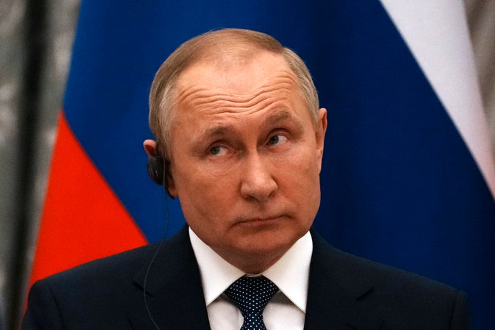 Russian President Vladimir Putin reacts during a joint press conference with French President Emmanuel Macron after their talks in Moscow, Russia, Feb. 7, 2022. (AP Photo/Thibault Camus, Pool, File)
