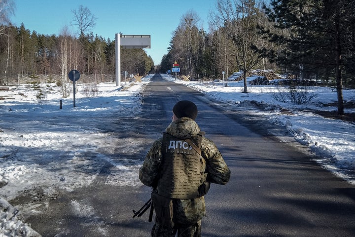 A member of the Ukrainian State Border Guard stands watch at the border crossing between Ukraine and Belarus, where Russian forces are conducting large-scale military exercises.