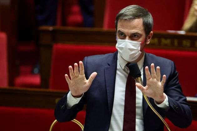 French Health Minister Olivier Veran, wearing a protective face mask, gestures during the opening debate...