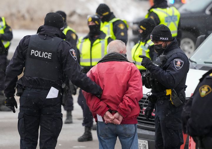 A protester is arrested in Windsor, Ontario, Sunday, Feb. 13, 2022. (Nathan Denette/The Canadian Press via AP)