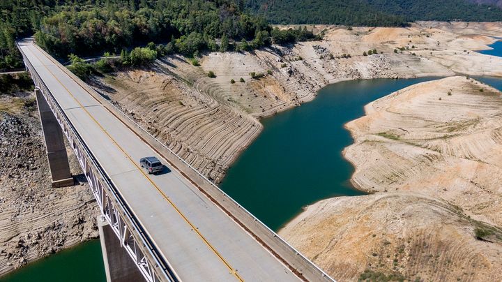 A car crosses Enterprise Bridge over Lake Oroville's dry banks on May 23, 2021, in Oroville, Calif., in this file photo. (AP Photo/Noah Berger, File)