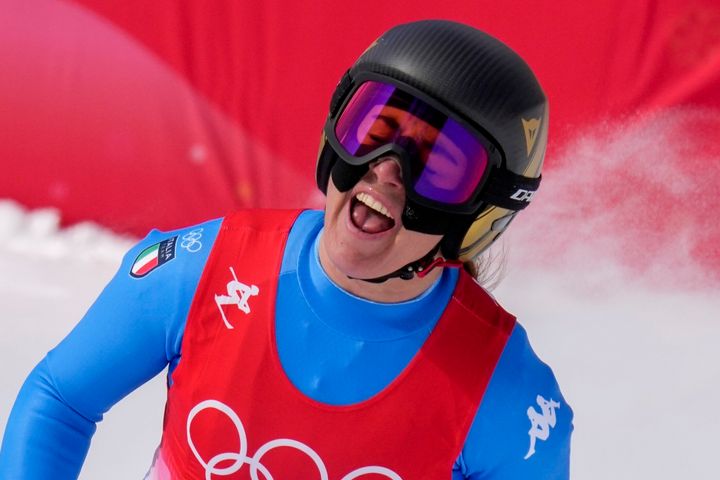 Sofia Goggia, of Italy, celebrates after finishing the women's downhill at the 2022 Winter Olympics.