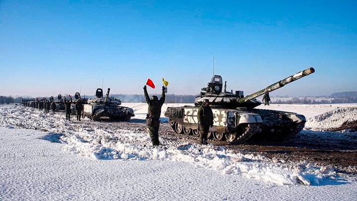 In this photo taken from video provided by the Russian Defense Ministry Press Service on Feb. 15, 2022, Russian army tanks stand ready to move back to their permanent base after drills in Russia.