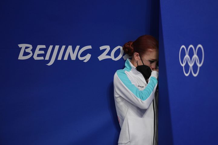 Silver medalist Alexandra Trusova reacts during the flower ceremony after the women's figure skating event.