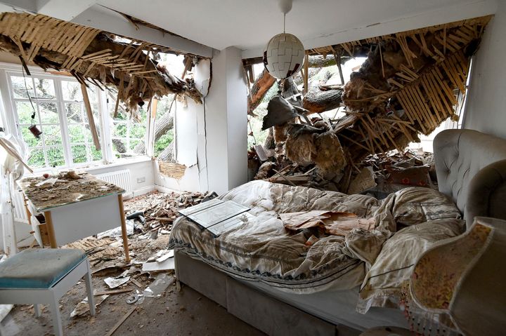 Debris is seen in a bedroom at the home of Dominic Good a day after a 400-year-old oak tree in the garden was uprooted by Storm Eunice, in Stondon Massey, near Brentwood, Essex, England, Saturday Feb. 19, 2022. 