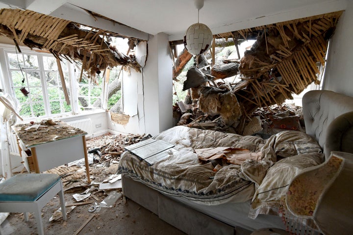 Debris is seen in a bedroom at the home of Dominic Good a day after a 400-year-old oak tree in the garden was uprooted by Storm Eunice, in Stondon Massey, near Brentwood, Essex, England, Saturday Feb. 19, 2022.