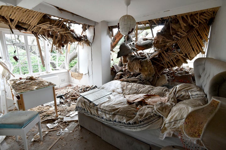 Debris is seen in a bedroom at the home of Dominic Good a day after a 400-year-old oak tree in the garden was uprooted by Storm Eunice, in Stondon Massey, near Brentwood, Essex, England, Saturday Feb. 19, 2022. 