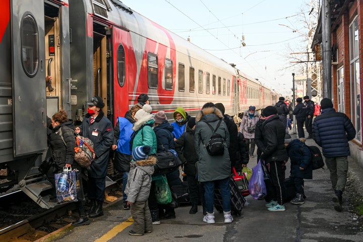 People from Donetsk, the territory controlled by a pro-Russia separatist government in eastern Ukraine, line up to get a train into Russia after evacuating in the Rostov-on-Don region, near the border with Ukraine, on Sunday.