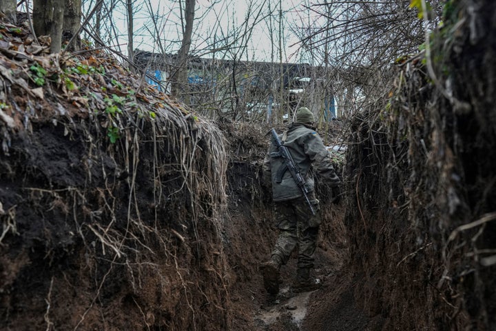 A Ukrainian serviceman walks to check a trench on a position at the line of separation between Ukraine-held territory and rebel-held territory near Zolote, Ukraine, late Saturday.