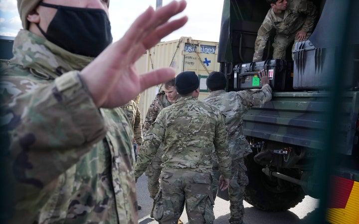 U.S. troops load equipment onto vehicles in Rzeszow, Poland, on Saturday. The U.S. recently sent nearly 5,000 troops to NATO ally Poland, in addition to the 4,000 that are on a permanent rotation in Poland.