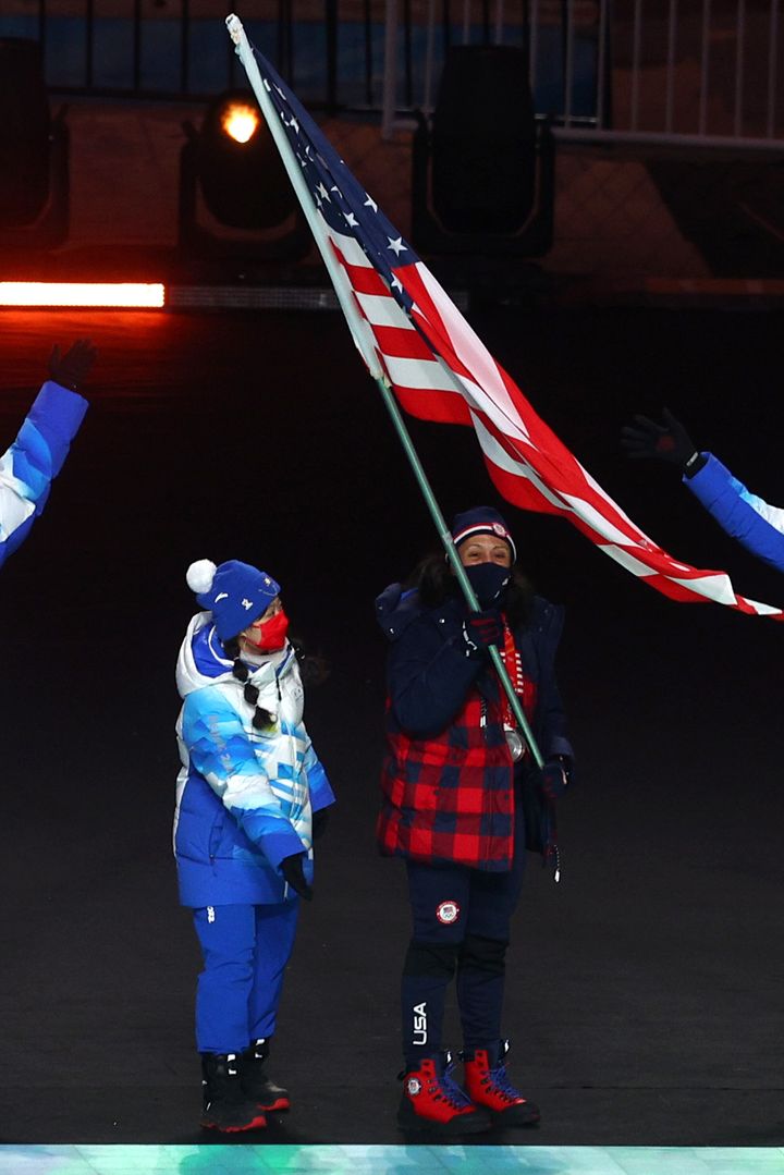 Elana Meyers Taylor waves the U.S. flag at the closing ceremony.