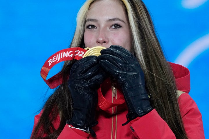 Gold medalist China's Eileen Gu kisses her medal during a medal ceremony for the women's freestyle skiing halfpipe competition at the 2022 Winter Olympics, Friday, Feb. 18, 2022, in Zhangjiakou, China. (AP Photo/Alessandra Tarantino)