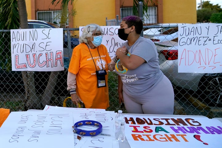 Vanny Veras, of the Miami Workers Center, right, talks with tenant Ana Sierra, 85, left, during a protest outside of an apartment building where residents are facing a steep increase in rent.