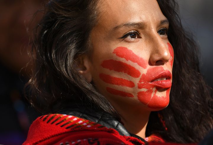 Micaela Iron Shell has painted red hands over their mouth to show solidarity for missing and murdered indigenous, black and migrant women and children during a rally with Climate activist Greta Thunberg at Civic Center Park on October 11, 2019 in Denver, Colorado.