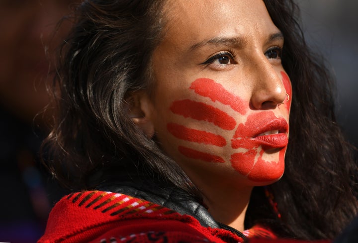 Micaela Iron Shell has painted red hands over their mouth to show solidarity for missing and murdered indigenous, black and migrant women and children during a rally with Climate activist Greta Thunberg at Civic Center Park on October 11, 2019 in Denver, Colorado.