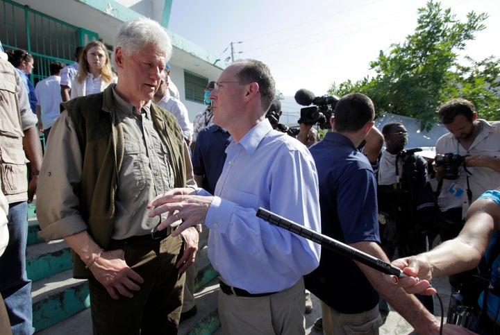 Former U.S. President Bill Clinton, left, talks with Dr. Paul Farmer, right, while touring the General Hospital in Port-au-Prince, Haiti, in 2010.