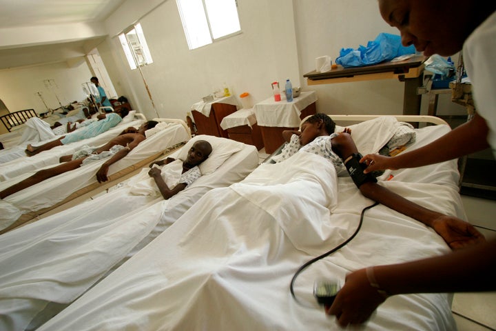 A nurse checks the pulse of a patient at Dr. Paul Farmer's Zanmi Lasante Hospital in Cange, Haiti in 2006. Farmer co-founded Partners in Health, a pioneering medical mission in Haiti's highlands that gives free treatment to thousands.