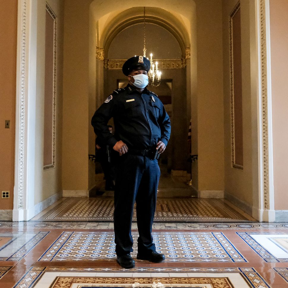 U.S. Capitol Police officer and Iraq War veteran Eugene Goodman, seen here in 2022, stands in the Senate hall that he bravely defended on Jan. 6, 2021, in Washington, D.C.