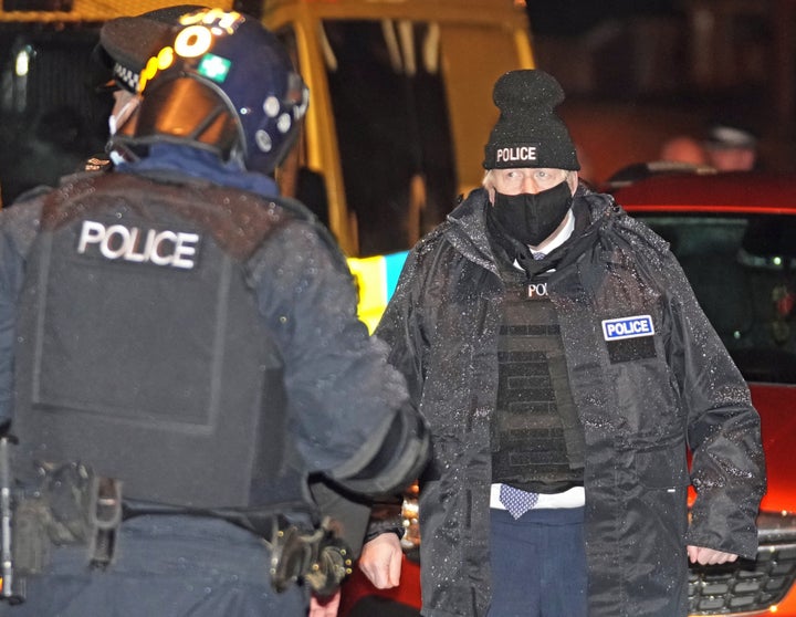 Prime Minister Boris Johnson observes an early morning Merseyside Police raid on a home in Liverpool 