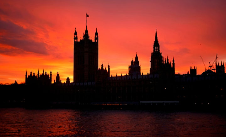 The sun sets behind the Palace of Westminster, the home of the Houses of Parliament in central London