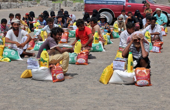 Yemenis displaced by conflict receive food aid at a camp in the war-ravaged western province of Hodeida on Feb. 23, 2022.
