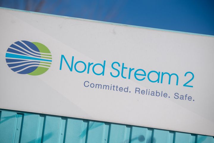 A sign reading "Nord Stream 2 Committed. Reliable. Safe." hangs above a painted map at an information point on the Nord Stream 2 gas pipeline in the Lubmin industrial park. Against the backdrop of the escalating Russia-Ukraine conflict, the German government is halting the approval process for the Russian-German Nord Stream 2 natural gas pipeline until further notice.