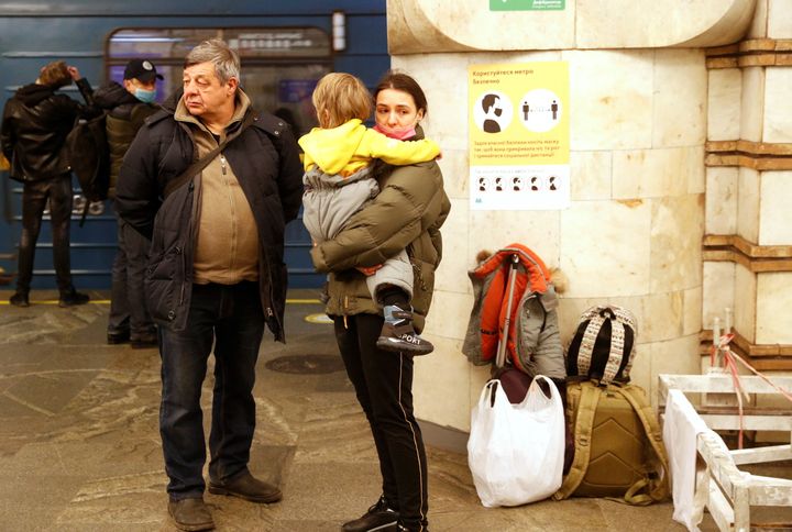 People take shelter in a subway station, after Russian President Vladimir Putin authorized a military operation in eastern Ukraine