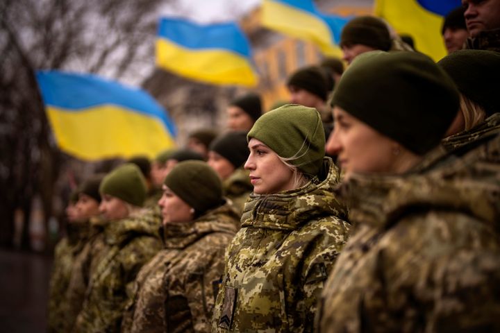 Ukrainian Army soldiers pose for a photo as they gather to celebrate a Day of Unity in Odessa, Ukraine, Wednesday, Feb. 16, 2022. (AP Photo/Emilio Morenatti)