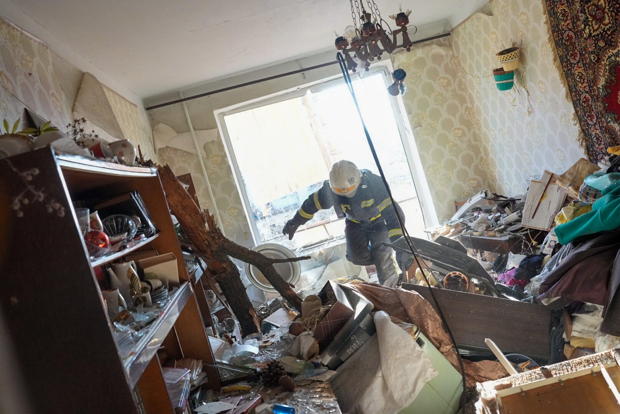 Ukrainian firefighters arrive to rescue civilians after an airstrike hit an apartment complex in Chuhuiv, Kharkiv Oblast.