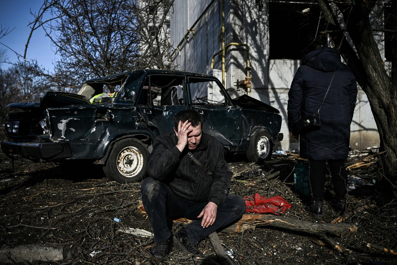 A man sits outside his destroyed building on Thursday after bombings in the eastern town of Chuguiv. 