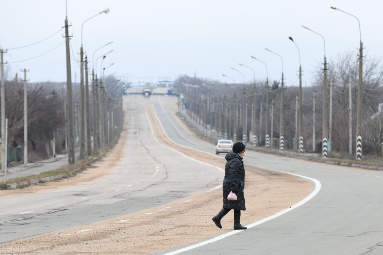 A woman crosses a road in Ukraine's Donetsk region, which was already under the control of pro-Russian separatists.