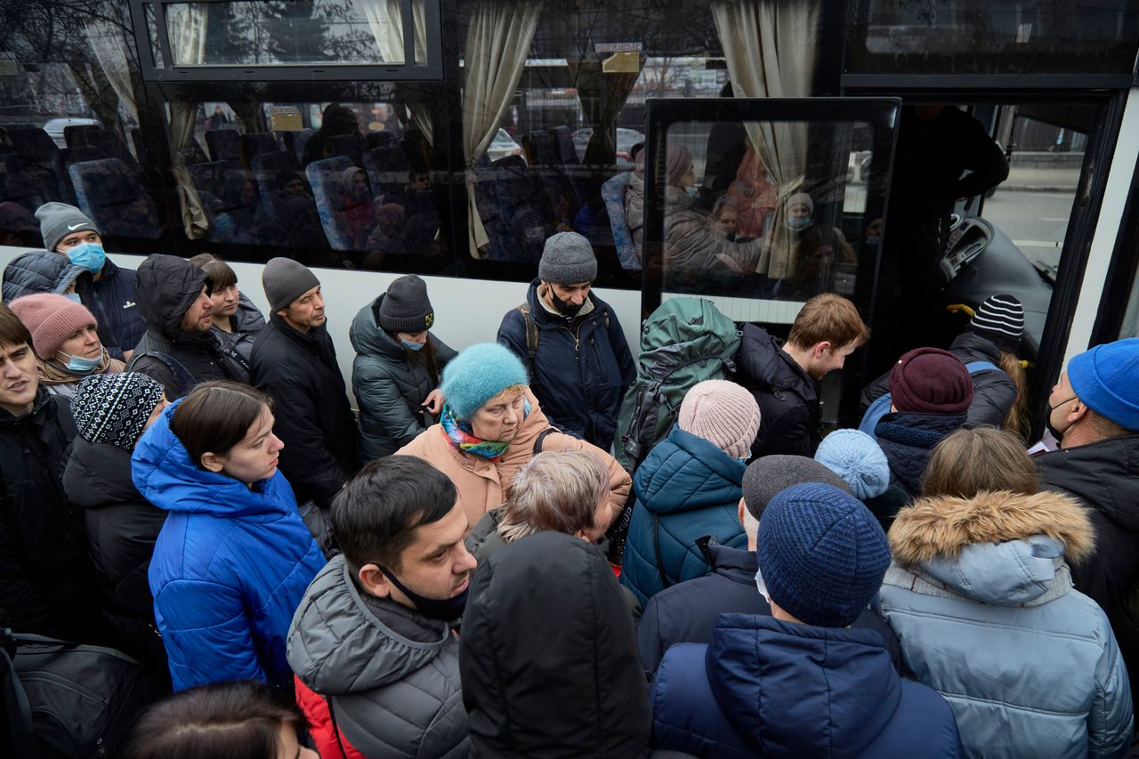 People board a bus as they attempt to evacuate Kyiv.