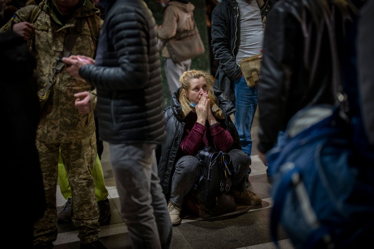 A woman waits for a train to leave Kyiv. 