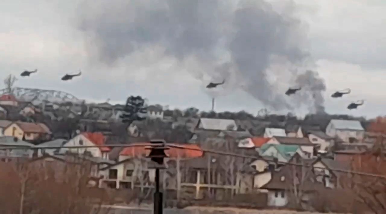 In this handout photo taken from video released by Ukrainian Police Department Press Service, military helicopters — apparently Russian — fly over the outskirts of Kyiv.