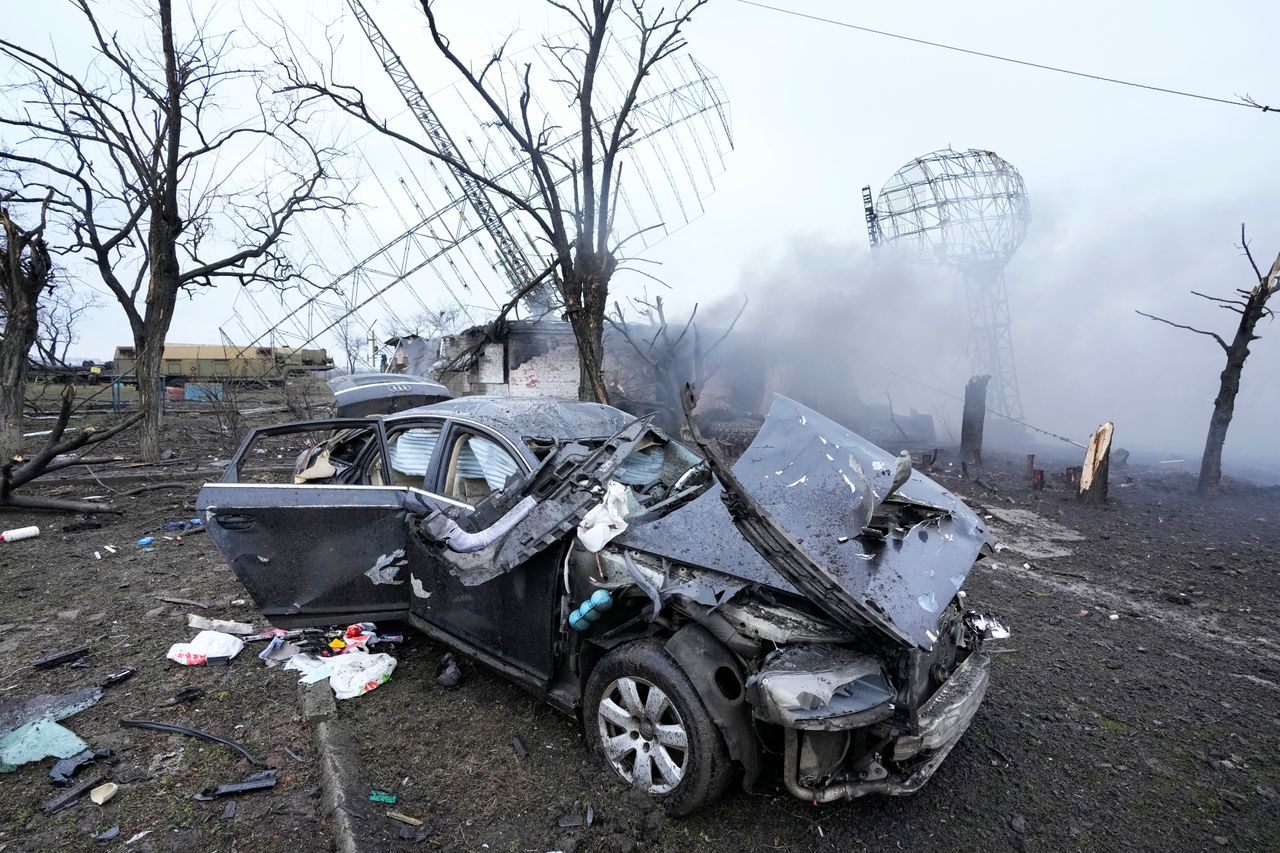 Damaged radar, a vehicle and equipment at a Ukrainian military facility.