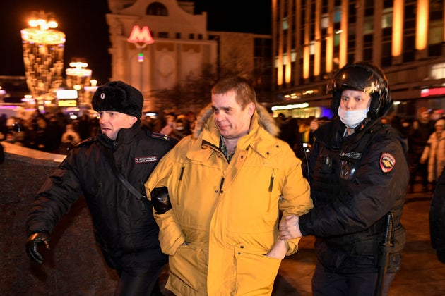 Police officers detain a demonstrator during a protest against Russia's invasion of Ukraine in Moscow on February 24, 2022.