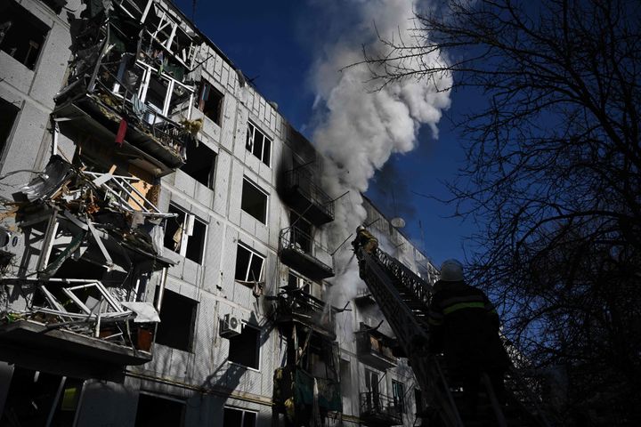 Firefighters handle a building fire after bombings on the eastern Ukraine town of Chuhuiv on Feb. 24.