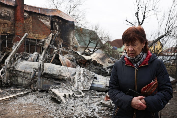 A person walks around the wreckage of an unidentified aircraft that crashed into a house in a residential area, after Russia launched a massive military operation against Ukraine, in Kyiv, Ukraine February 25, 2022. REUTERS/Umit Bektas