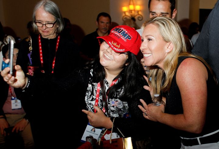 Rep. Marjorie Taylor Greene (R-Ga.) poses for a picture with a Donald Trump supporter at the Conservative Political Action Conference (CPAC) in Orlando, Florida, on Friday. Greene later spoke at AFPAC.