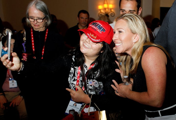 Rep. Marjorie Taylor Greene (R-Ga.) poses for a picture with a Donald Trump supporter at the Conservative Political Action Conference (CPAC) in Orlando, Florida, on Friday. Greene later spoke at AFPAC.