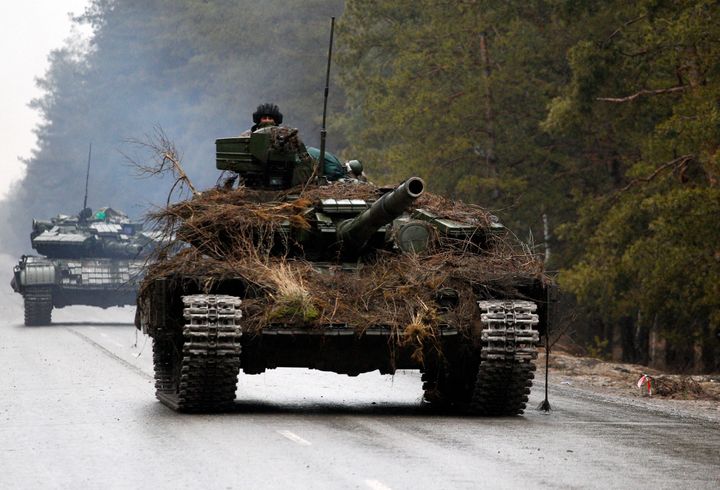 Ukrainian tanks move on a road before an attack in Lugansk region on February 26, 2022.