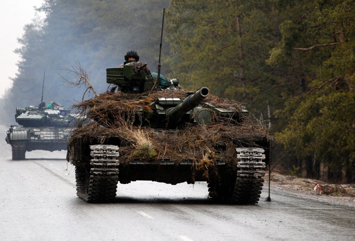 Ukrainian tanks move on a road before an attack in Lugansk region on February 26, 2022.