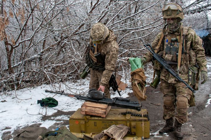Ukrainian soldiers handle equipment outside Kharkiv, Ukraine, Saturday, Feb. 26, 2022. (AP Photo/Andrew Marienko)