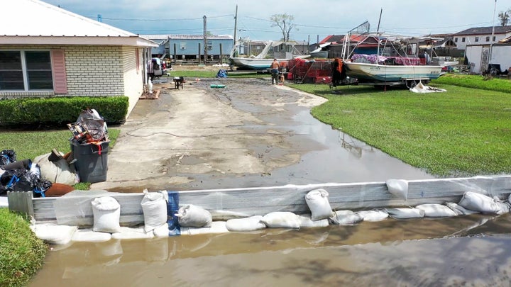 A property with a makeshift levee is shown at Des Allemands, Louisiana, in August 2021 a couple of days after Hurricane Ida made landfall. (AP Photo/Steve Helber)