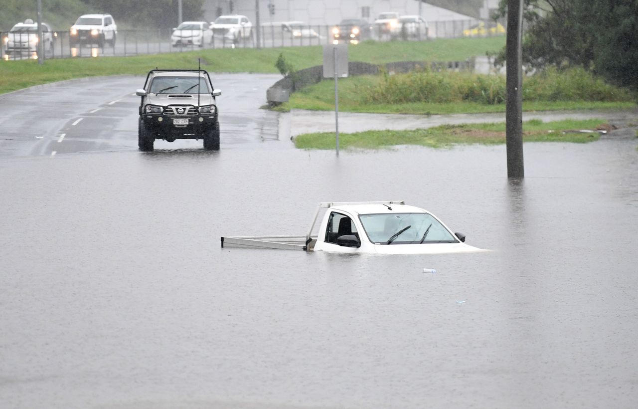 A vehicle is submerged in flood water on February 26, 2022, in the suburb of Oxley in Brisbane, Australia.
