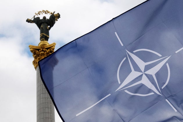 NATO flag flies in front of the Independence monument during a rally to thank foreign states for supplying Ukraine with weapons and their international support at the Independence Square in Kyiv, Ukraine 30 Janury 2022. The US have sent military aid including Javelin anti-tank missiles, and Britain provided Next generation Light Anti-tank Weapon (NLAW) to Ukraine as Russia border tensions. (Photo by STR/NurPhoto via Getty Images)