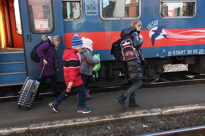 Ukrainian refugees arrive at the railway station in the Hungarian-Ukrainian border town of Zahony.