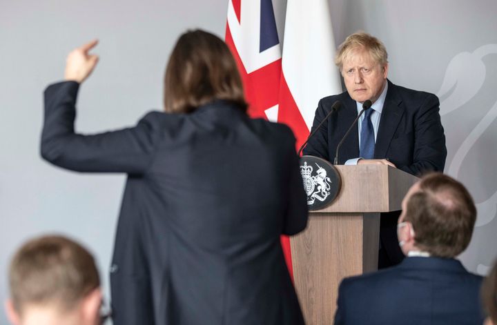 British Prime Minister Boris Johnson takes a question from Ukrainian journalist Daria Kaleniuk about the no-fly zone during a press conference at the British Embassy on March 1 in Warsaw.